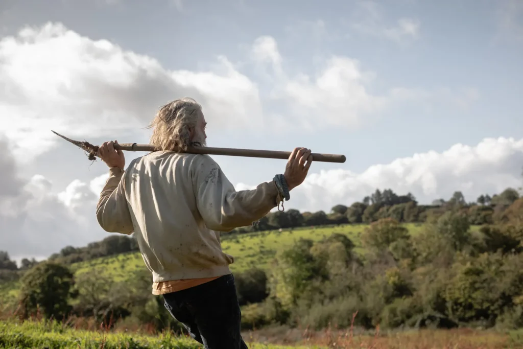 Irish flax farmer working on his organic farm 